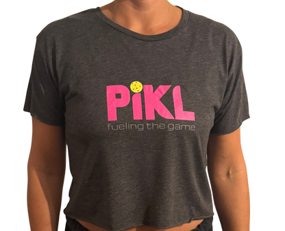 Person wearing a dark gray t-shirt with 'Pikl' logo and text on a white background